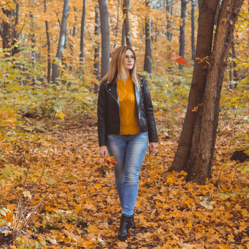 Woman walking in Autumn woodland