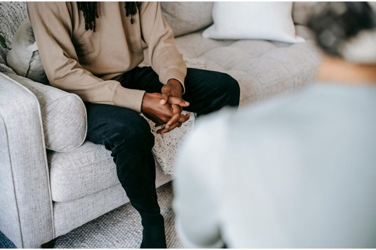 Person on a therapy couch representing hypnotherapy and counselling together.