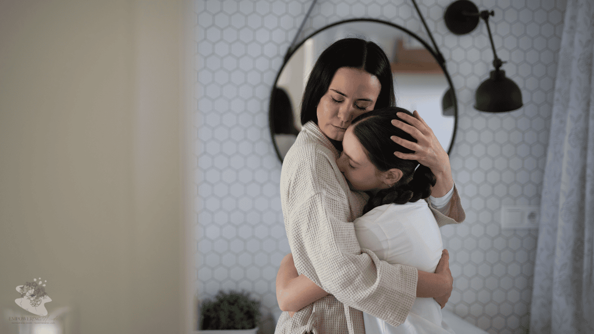 Mum hugging her teenage daughter at home